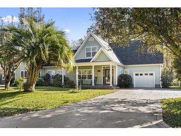 Charming one-story home with a well-manicured lawn and a beautiful palm tree at 1044 Martin Ln., Conway, SC 29526