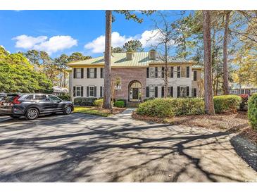 Elegant two-story home featuring a lush green yard and a private driveway with ample parking at 110-1 Whitetail Way # 1, Pawleys Island, SC 29585