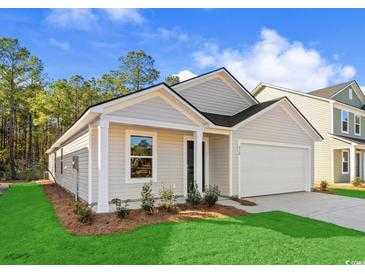 Charming single-story home with attached garage, manicured lawn, and fresh landscaping for enhanced curb appeal at 1230 Willow Oaks Way, Conway, SC 29526