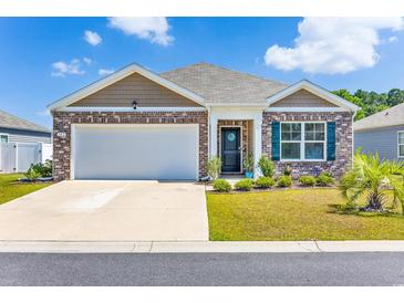 Charming single-story brick home featuring a well-manicured lawn, garage, and inviting front porch at 142 Pine Forest Dr., Conway, SC 29526