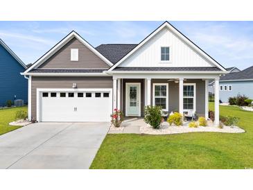 Charming single-story home featuring a manicured lawn, covered porch, and a two-car garage at 314 Bumble Circle, Murrells Inlet, SC 29576