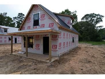 New construction home featuring durable materials and a simple porch design at 402 S Magnolia Ave., Andrews, SC 29510