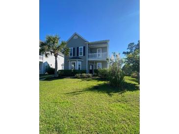 Charming two-story home with a well-maintained lawn and beautiful landscaping at 493 Emerson Dr., Myrtle Beach, SC 29579