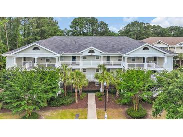 Attractive multi-Gathering home with a pathway, covered entryways and balconies, and lush landscaping at 5825 Catalina Dr. # 523, North Myrtle Beach, SC 29582