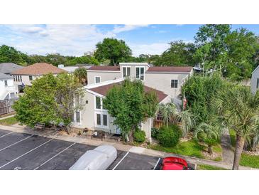 Inviting exterior view of home with mature trees, an American flag and private parking at 800 9Th Ave. S # E-4, North Myrtle Beach, SC 29582
