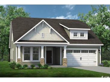Charming home featuring a covered front porch, attached two-car garage, and manicured front lawn at 835 Big Cedar Dr., Loris, SC 29569