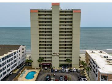 Oceanfront condo building with a pool and parking at 912 N Waccamaw Dr. # 904, Garden City Beach, SC 29576