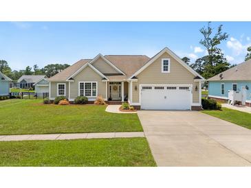 Charming single-story home featuring a well-manicured lawn, two-car garage, and inviting facade at 1149 6Th Ave. S, North Myrtle Beach, SC 29582