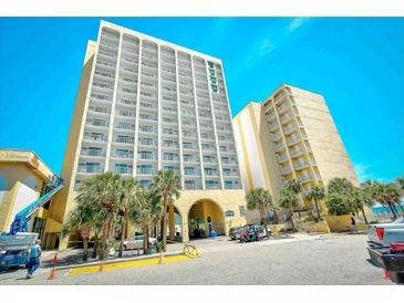 Stunning view of the building exterior featuring multiple balconies and covered entryway at 1207 S Ocean Blvd. # 50809, Myrtle Beach, SC 29577