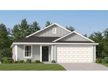 Charming single story home with gray siding, black door, an attached two car garage, and neatly manicured lawn at 1218 Willow Oaks Way, Conway, SC 29526