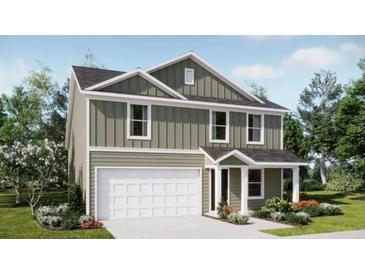 Charming two-story home with a light green exterior, white trim, attached garage, and well-manicured front yard at 1222 Willow Oaks Way, Conway, SC 29526