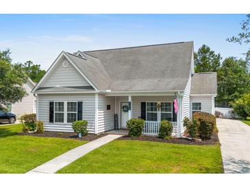 Charming single story home with manicured lawn, walkway, gray siding, black shutters, and a cozy front porch at 136 Southbury Dr., Myrtle Beach, SC 29588
