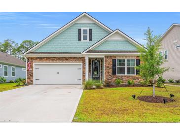 Charming single-Gathering home with stone and shake siding, manicured lawn and attached two-car garage at 1523 Wood Stork Dr., Conway, SC 29526
