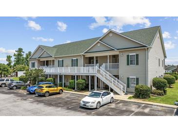 Well-maintained condo with green roof, white railing, and convenient parking at 141 Lazy Willow Ln. # 103, Myrtle Beach, SC 29577