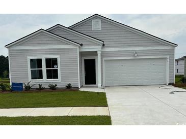 Charming single-story home showcasing a well-manicured lawn and a two-car garage, perfect for modern living at 171 Waterloo Sunset Dr., Longs, SC 29568