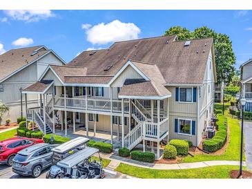 Inviting two-story condo with upper-level deck, manicured landscaping, and convenient parking at 1870 Auburn Dr. # 22A, Surfside Beach, SC 29575