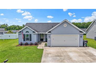 Charming single-story home with a manicured lawn, attached garage, and inviting curb appeal at 282 Foxpath Loop, Myrtle Beach, SC 29588