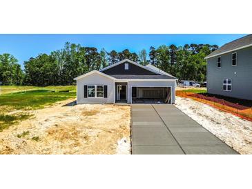 Charming one-story home with gray siding, concrete driveway and attached garage in a serene neighborhood at 420 Meadow Sweet Pl, Conway, SC 29526