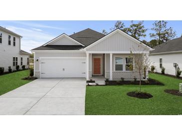 Charming single-story home with a gray exterior, well-manicured lawn, and a two-car garage at 4846 Hopespring St., Myrtle Beach, SC 29579