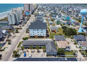 An aerial view of a coastal neighborhood with a building under construction near the beach at 5909 N Ocean Blvd. # 18, North Myrtle Beach, SC 29582
