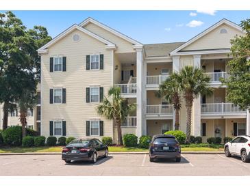 Inviting condo building featuring palm trees, well-manicured landscaping, and convenient parking at 601 Hillside Dr. N # 1931, North Myrtle Beach, SC 29582