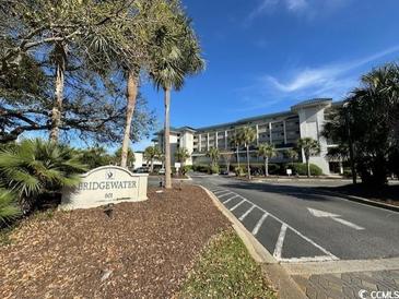 Attractive condo complex with lush landscaping and an inviting entrance at 601 Retreat Beach Circle # 521, Pawleys Island, SC 29585