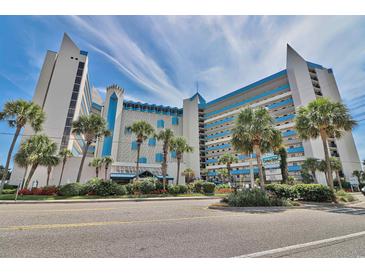 Beautiful exterior view of the condo building with blue accents and tropical landscaping at 7100 North Ocean Blvd. # 617, Myrtle Beach, SC 29577