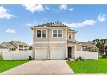Inviting two-story home featuring double garages, manicured lawn, and charming curb appeal at 79 S Reindeer Rd., Surfside Beach, SC 29575