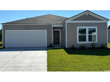 Charming single-story home with a gray exterior, attached garage, and well-maintained lawn at 863 Long Beach Dr, Longs, SC 29568