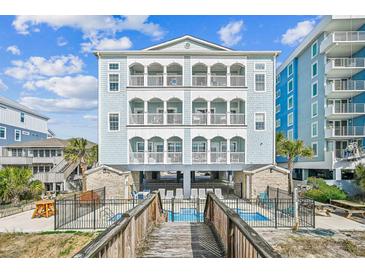 Stunning beachfront home with multiple balconies overlooking a refreshing pool and featuring a private walkway at 931 S Ocean Blvd., North Myrtle Beach, SC 29582