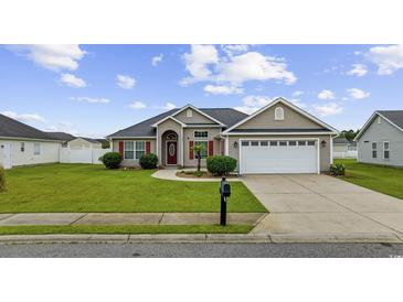 Charming single-story home with well-manicured lawn, red door, and two-car garage at 1205 Cymmer Ct., Conway, SC 29527