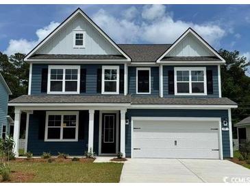 Charming two-story home with a symmetrical facade, a two-car garage, and a well-maintained front lawn at 137 Stride Ct., Myrtle Beach, SC 29588