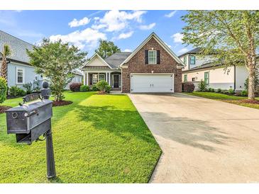 Charming brick home with a well-manicured lawn and a two-car garage at 1410 Bohicket Ct., Myrtle Beach, SC 29579