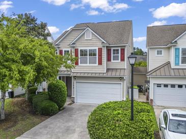 Charming two-story home featuring a two-car garage, well-manicured lawn, and red shutters adding a pop of color at 185 Fulbourn Pl., Myrtle Beach, SC 29579