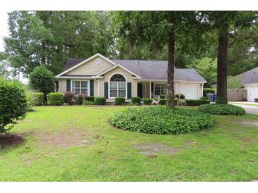 Charming single-story home with well-manicured lawn, lush landscaping, and inviting curb appeal at 3001 Dewberry Dr., Conway, SC 29527