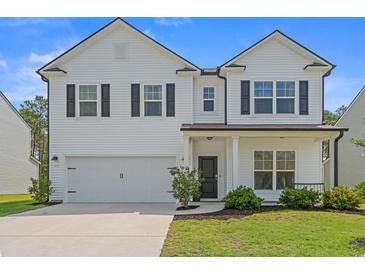 Charming two-story home with a well-maintained lawn, attached garage and inviting front porch at 625 Heritage Downs Dr., Conway, SC 29526