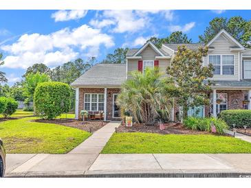 Charming townhouse with red shutters, brick accents, and well-manicured landscaping at 701 Wilshire Ln. # 0, Murrells Inlet, SC 29576