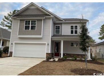 Charming two-story home with light-grey siding, well-manicured lawn and a two car attached garage at 731 Rupert Dr, Conway, SC 29526