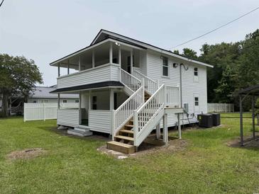 Two-story home featuring white siding, covered porches, and stairway at 1022 Holt Rd., Conway, SC 29526