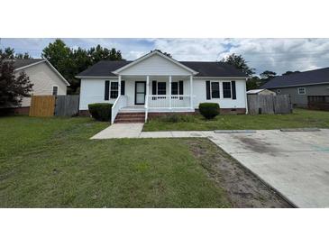 Charming one-story home with white siding, a cozy front porch, and a well-maintained lawn at 1041 Morning Dale St., Conway, SC 29526