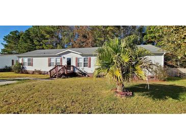 Charming single-story home featuring a well-manicured lawn and a classic, inviting entryway at 1089 Weslin Creek Dr., Myrtle Beach, SC 29588