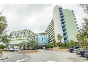 Inviting entrance to Coral Beach Resort with well-maintained landscaping and ample parking at 1105 S Ocean Blvd. # 932, Myrtle Beach, SC 29577