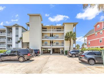South Shores building featuring parking, balconies, and a sign at 1119 S Ocean Blvd. # 8, Surfside Beach, SC 29575