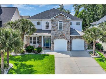 Beautiful two-story home with a stone facade and well-maintained landscaping and two-car garage at 1619 Eastover Ln., North Myrtle Beach, SC 29582