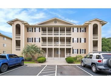 Three-story condo complex showcasing private balconies and well-manicured landscaping at 1900 Duffy St. # L4, North Myrtle Beach, SC 29582