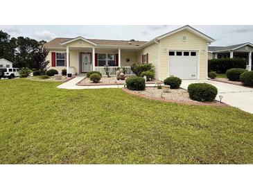 Lovely home with red shutters, a well kept lawn, landscaped garden, and a charming front porch at 216 Walden Lake Rd., Conway, SC 29526