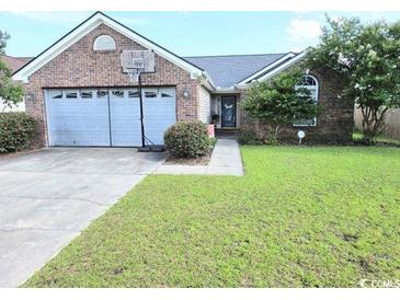 Charming single Gathering house featuring an attached garage, well-manicured lawn, and lovely curb appeal at 2707 Canvasback Trail, Myrtle Beach, SC 29588