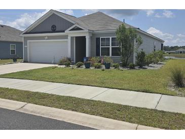 Charming single-story home with a well-manicured lawn and attached two-car garage in a residential community at 297 Harvest Ridge Way, Conway, SC 29527