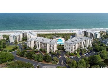 Aerial view of oceanfront condos with a pool, beautiful landscaping and beach access at 341 South Dunes Dr. # C-34, Pawleys Island, SC 29585