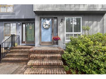 Charming home featuring a blue front door adorned with a wreath and lovely brick steps at 403 75Th Ave N # C, Myrtle Beach, SC 29572